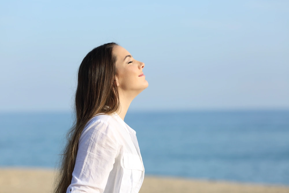 A woman enjoying a calm moment at the beach