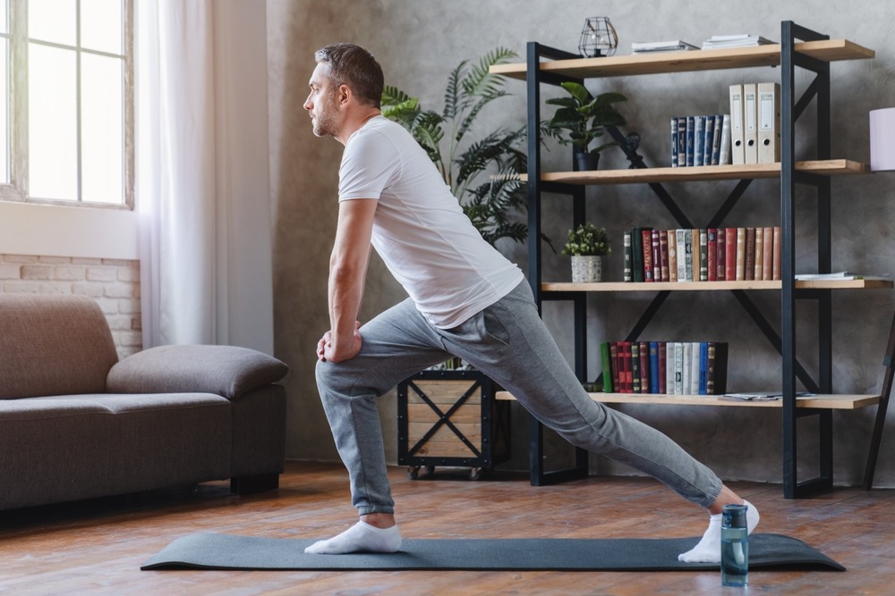 Middle age man doing fitness workouts at home.