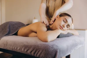 Professional massage therapist working on client's neck and shoulders